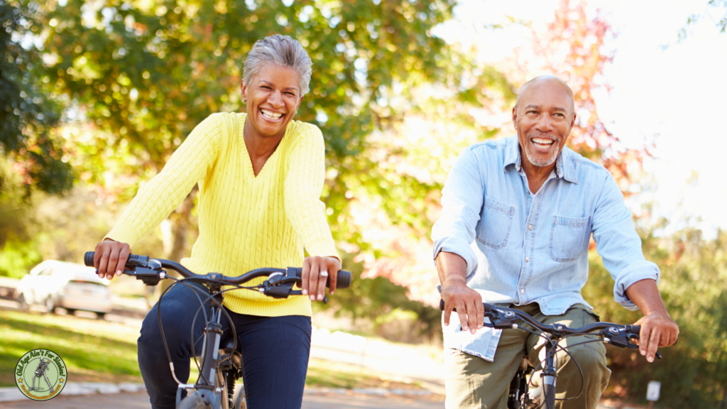 Elderly couple smiling while riding on bikes